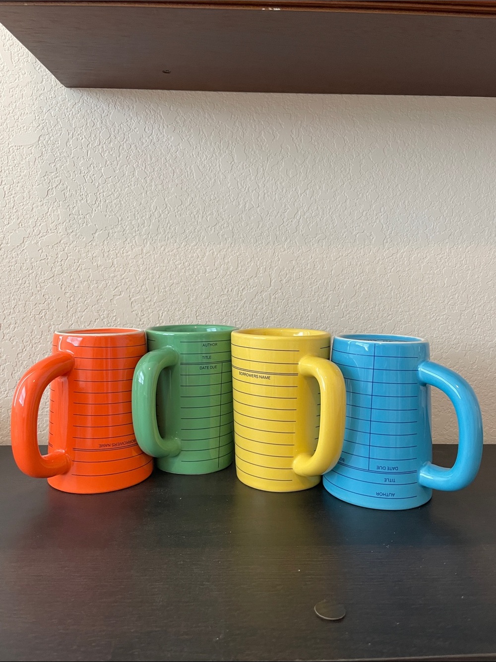 Out of Print Orange, Green, Yellow & Blue Library Card Ceramic Mugs